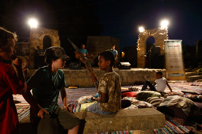 An African child talks with Maltese children during a musical integration party at the Peace Lab complex in Hal Far, outside Valletta, June 25, 2013. Run by Franciscan friars, the Peace Lab is home to around fifty adult migrants and their children, all of whom had been rescued by the Maltese Armed Forces while attempting to reach European soil from Africa. 