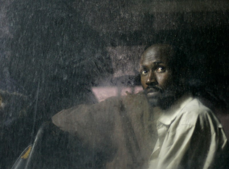 A Somali man looks out of the window of a police bus after arriving in the fishing village of Marsaxlokk, in the southeast of Malta, May 26, 2007. Twenty-nine Somali asylum seekers were intercepted aboard a makeshift boat seven miles south-west of the Maltese islands on their way to reach European soil from Africa.