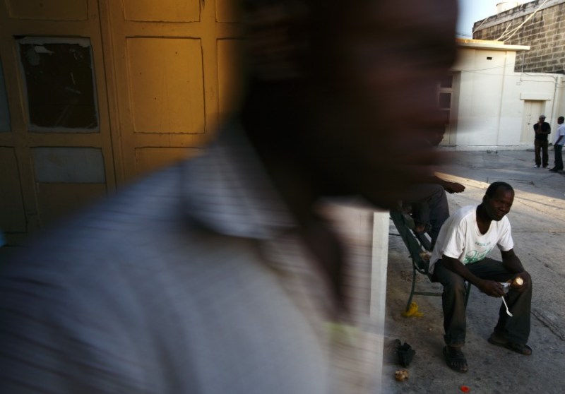 An African man eats his meal during Eid al-Fitr celebrations to mark the end of Ramadan at the Marsa Open Centre for Refugees and Asylum Seekers in Marsa in Valletta's Grand Harbour September 10, 2010.  