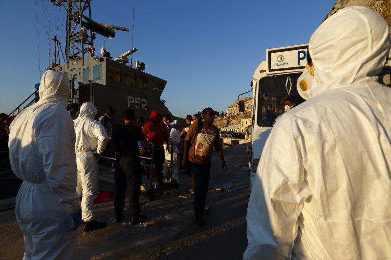 Rescued refugees disembark from an Armed Forces of Malta (AFM) patrol boat after arriving at the AFM's Maritime Squadron base at Haywharf in Valletta's Marsamxett Harbour, August 28, 2014. A total of 257 people from Syria, Iran, Iraq, the Palestinian Territories and Senegal, arrived in Malta on Thursday evening after they were rescued from a sinking boat by a cargo ship and transferred to AFM patrol boats.