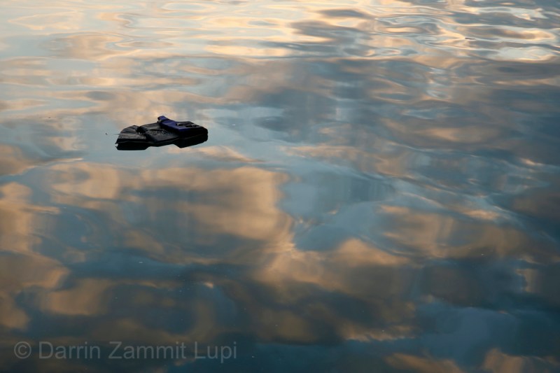 A lifejacket floats on the surface of the water at the port of Mytilene on the Greek island of Lesbos